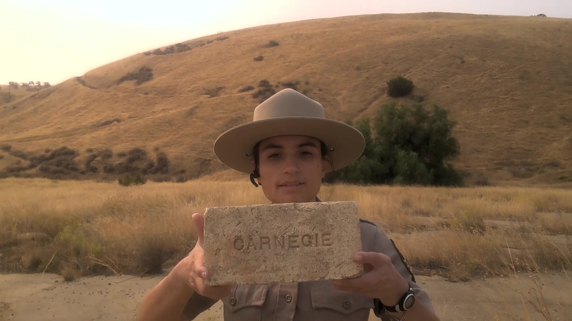 Interpreter holding a Carnegie Brick Interpreter holding a Carnegie Brick